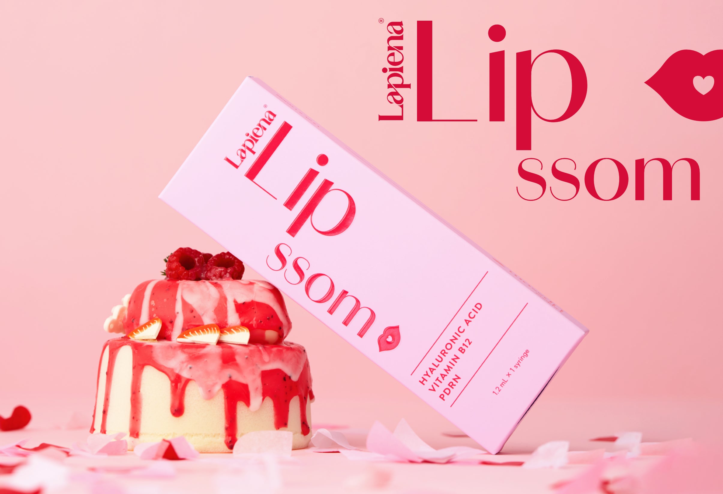pink lapiena lipssom lip booster product next to a cake on pink background with lipssom text