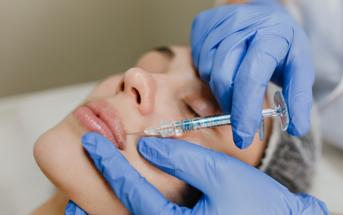 aesthetics nurse performing lip filler on a woman with dermal filler