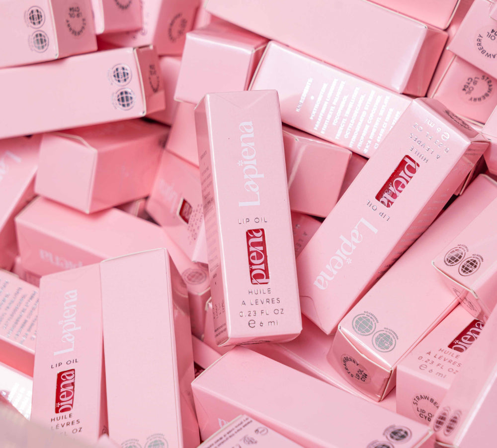 Pink boxes with lip oil writen and 'Lapiena' branding on a pink background